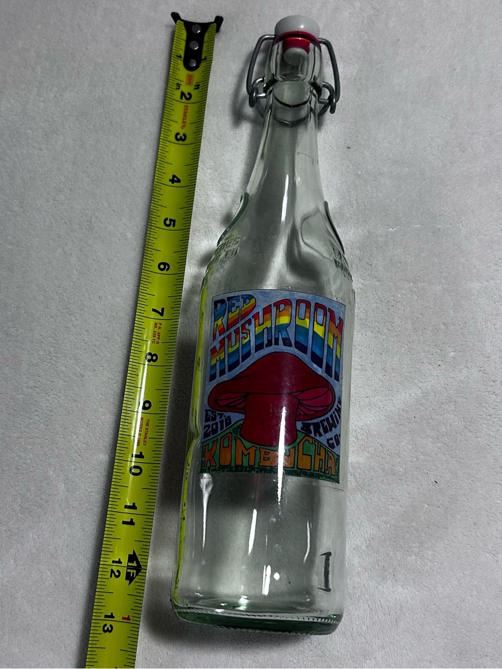 Red mushroom kombucha brewing June glass bottle swing top airtight fermentation